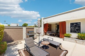 An outdoor patio with a grill, lounge chairs, and a dining table. - Your perfect Scottsdale escape with a private pool, spacious layout, and parking (Scottsdale)