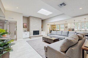 A spacious living room with a fireplace, a sofa, and a coffee table. - Your perfect Scottsdale escape with a private pool, spacious layout, and parking (Scottsdale)