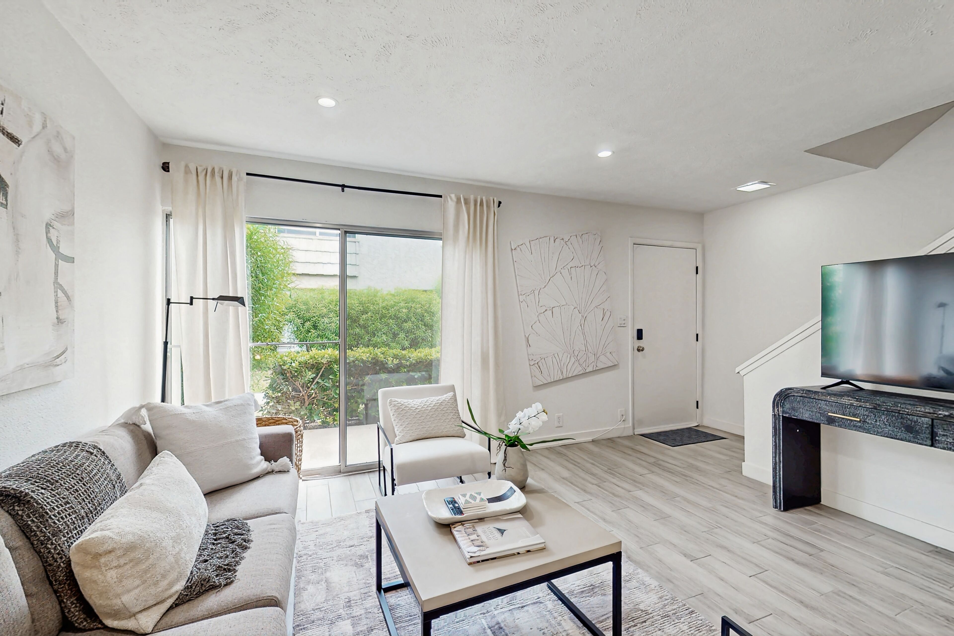 A modern living room with a sofa, coffee table, and a television.