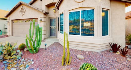 Southwestern home with colorful patio, sparkling pool, grill & dart board