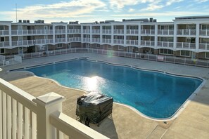 A swimming pool surrounded by a white fence, with a covered object near the pool's edge. - Oceanside Retreat in Mantoloking: Walk to Beach! (Mantoloking)