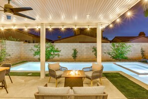 An outdoor patio with a pool, seating, and string lights. - Stunning Terra Lago Home w/Pvt. Grill, Pool & Spa+Next to Terra Lago Golf Course (Indio)