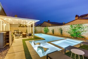 A modern outdoor pool area with a covered seating area, lounge chairs, and a barbecue setup. - Stunning Terra Lago Home w/Pvt. Grill, Pool & Spa+Next to Terra Lago Golf Course (Indio)