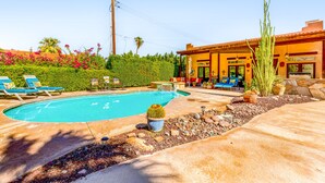 A swimming pool with lounge chairs, a cactus, and a building with a patio. - Mountain-view home with private pool & spa, near trails - 3BR #220080 (La Quinta)