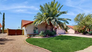 A residential house with a red-tiled roof, a well-maintained lawn, and a palm tree in the front yard. - Charming & sunlit villa with private pool, patio, & firepit - near golf & trails (Mesa)