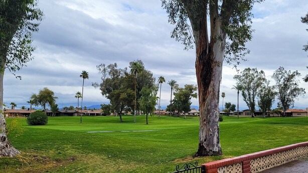 A well-maintained golf course with a brick pathway and decorative railing. - Snowbird-friendly golf-front home with pool, hot tub, grill, smart TVs, W/D, AC (Mesa)