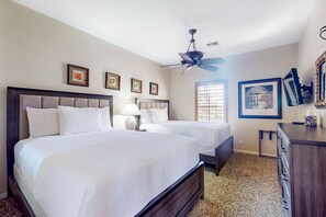 A hotel room with two beds, a ceiling fan, a dresser, and framed pictures on the walls. - Snowbird-friendly house with mountain view, pool, on-site golf, and central AC (Indio)