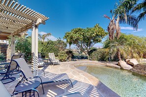 A pool area with lounge chairs and a pergola. - Snowbird-friendly house with mountain view, pool, on-site golf, and central AC (Indio)