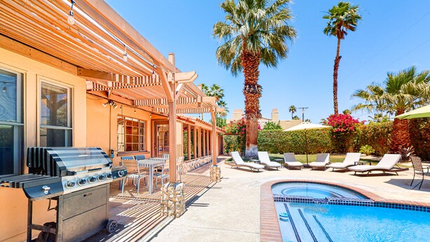 A poolside area with a barbecue grill, lounge chairs, and a swimming pool. - Siesta-ready home with private saltwater pool - close to downtown (Palm Springs)