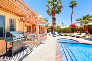 A poolside area with a barbecue grill, lounge chairs, and a swimming pool. - Siesta-ready home with private saltwater pool - close to downtown (Palm Springs)