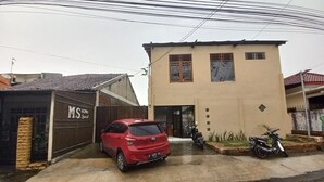 A two-story building with a garage labeled 'MS Home'. - OYO 95184 Ms Home Syariah (Tegal)