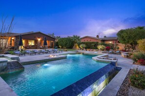 A swimming pool with lounge chairs and a patio area. - Luxury lakefront desert home w/ private pool, pool spa, putting greens (Rancho Mirage)