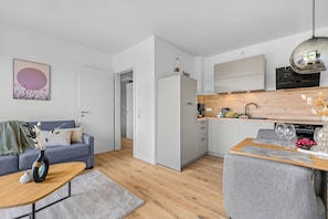 A modern apartment with a living area, kitchen, and dining space. - The View B02 Achter de Diek - beach chair, elevator, shared Sauna (Dagebüll)