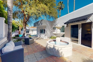 A patio area with outdoor furniture, a hot tub, and a pool. - Private Desert Gem W/ Private Pool/Spa, Gourmet Kitchen & More - Dogs OK (Palm Springs)