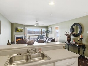 A kitchen with a large island, a double sink, and a view of a deck and outdoor area. - | Ledges | 3B 3B  | Boat Dock  | SeasonalPool | (Osage Beach)