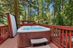 A hot tub on a wooden deck surrounded by trees. - Spacious dog-friendly cabin with creek & mountain views (Idyllwild)