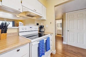 A kitchen with a stove, oven, and coffee maker. There are cabinets and a countertop. - Welcoming condo with WiFi & pool - near Scottsdale Fashion Square (Scottsdale)