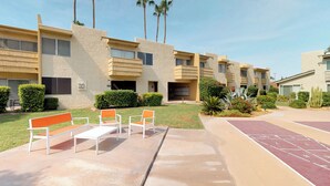 A modern hotel with a courtyard featuring outdoor seating and a shuffleboard court. - Welcoming condo with WiFi & pool - near Scottsdale Fashion Square (Scottsdale)