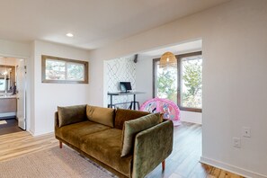 A modern living room with a brown sofa, a small table, and a decorative chair.