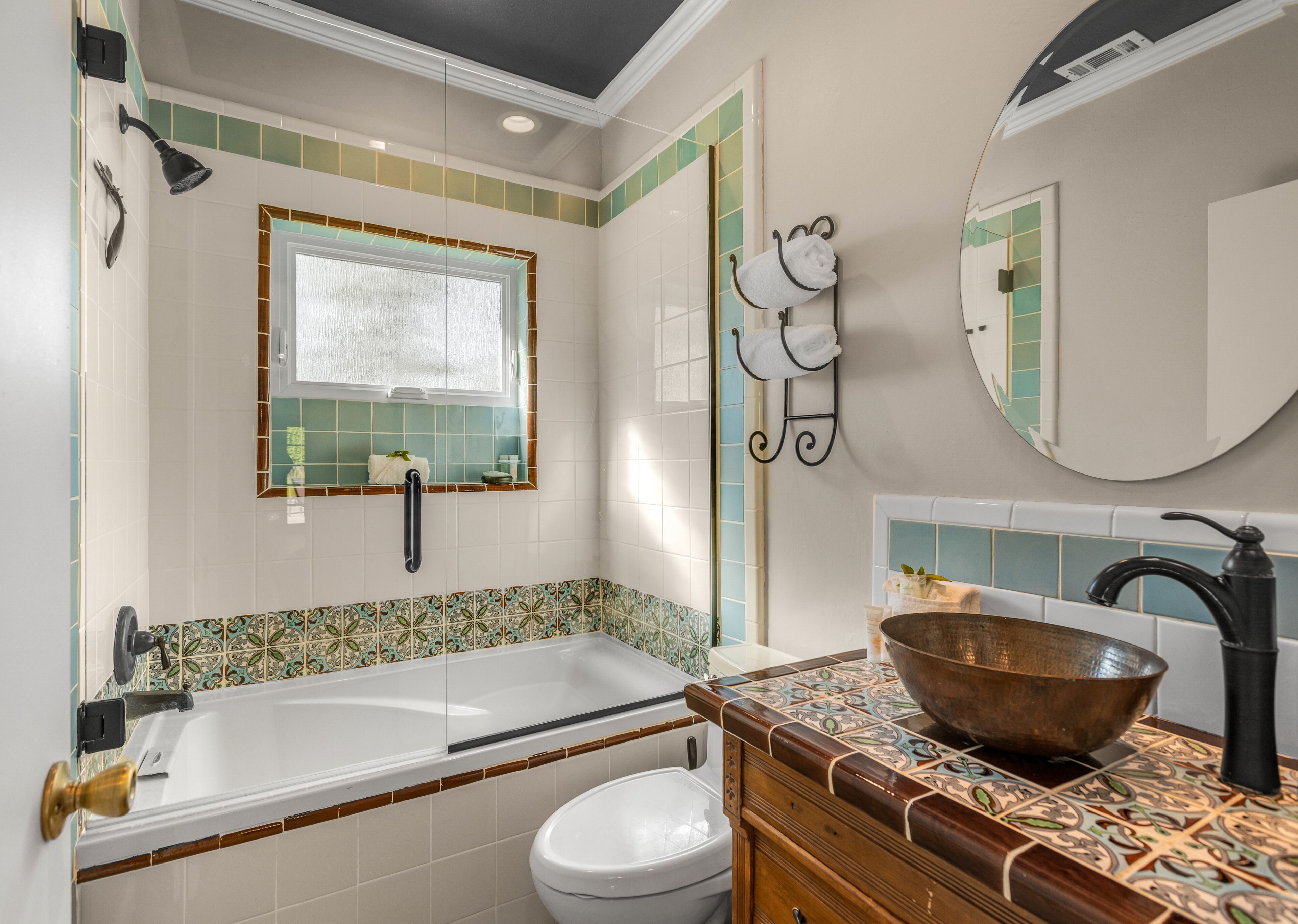 A bathroom with a bathtub, toilet, and sink.