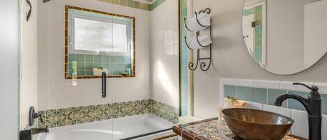 A bathroom with a bathtub, toilet, and sink.