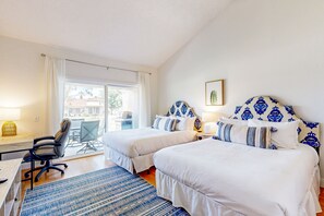 A hotel room with two beds, a desk, a chair, and a view of the outdoors. - Palm Desert Resorter | New Furnishings | 20 Pools, Championship Golf (Palm Desert)
