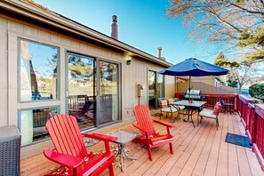 A deck with red Adirondack chairs, a table, and a grill. - Sunlit dog-friendly home with central AC, deck, & fireplace - near golf & trails (Flagstaff)