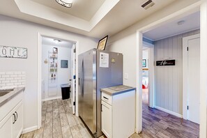 A modern kitchen with a stainless steel refrigerator, a built-in oven, and a countertop with a sink. - Sunlit dog-friendly home with central AC, deck, & fireplace - near golf & trails (Flagstaff)
