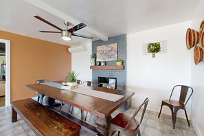 A dining area with a wooden table, benches, and chairs. - Saguaro Gardens desert retreat on 5 acres with pool, pool spa, & casita (Desert Hot Springs)