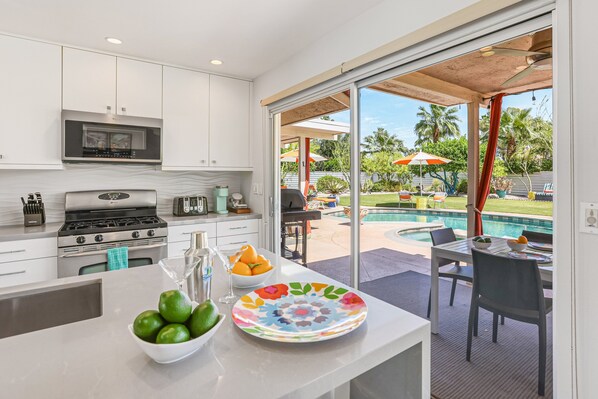 Fridge, microwave, oven, stovetop - Colorful home with stunning backyard, pool, spa, WiFi, central AC, and fireplace (Palm Springs)