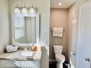 A bathroom with a vanity, a toilet, and a towel rack. - Wild West studio/ Montrose HTX/ Free Wifi (Houston)
