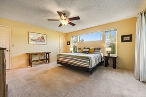 A bedroom with a bed, a ceiling fan, a window, and a nightstand. - Dog-friendly, Cave Creek home with covered patio, hot tub & mountain views (Cave Creek)