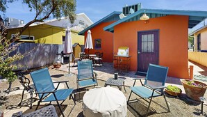 A patio with outdoor seating, a small table, and a potted plant. - Southwestern home in a great downtown Tucson location w/ furnished patio & yard (Tucson)