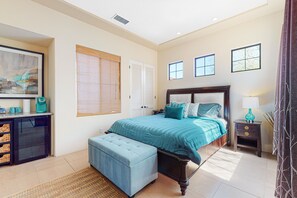 A bedroom with a bed, bedside table, and a desk with drawers. - Relaxing home & casita with private pool, pool spa, grill & outdoor fireplaces (Palm Desert)