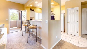 A room with a bed, a chair, a desk, and a window. - Dog-friendly condo with high-speed WiFi, heated outdoor pool & hot tub (Oro Valley)