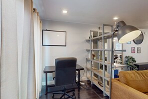 A modern office space with a desk, chair, bookshelf, and a lamp. - Modern condo w/ shared pool, pool spa, & tennis courts - close to ASU, airport (Tempe)
