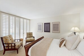 A hotel room with a bed, two armchairs, a lamp, and three framed artworks on the wall. - Exquisite retreat with pool, spa, fireplace, golf & mountain view, dog-friendly! (Indian Wells)