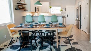 A modern kitchen with a dining table set for four, surrounded by chairs. - Two-story mountain view retreat with two primary suites & ideal layout (Flagstaff)