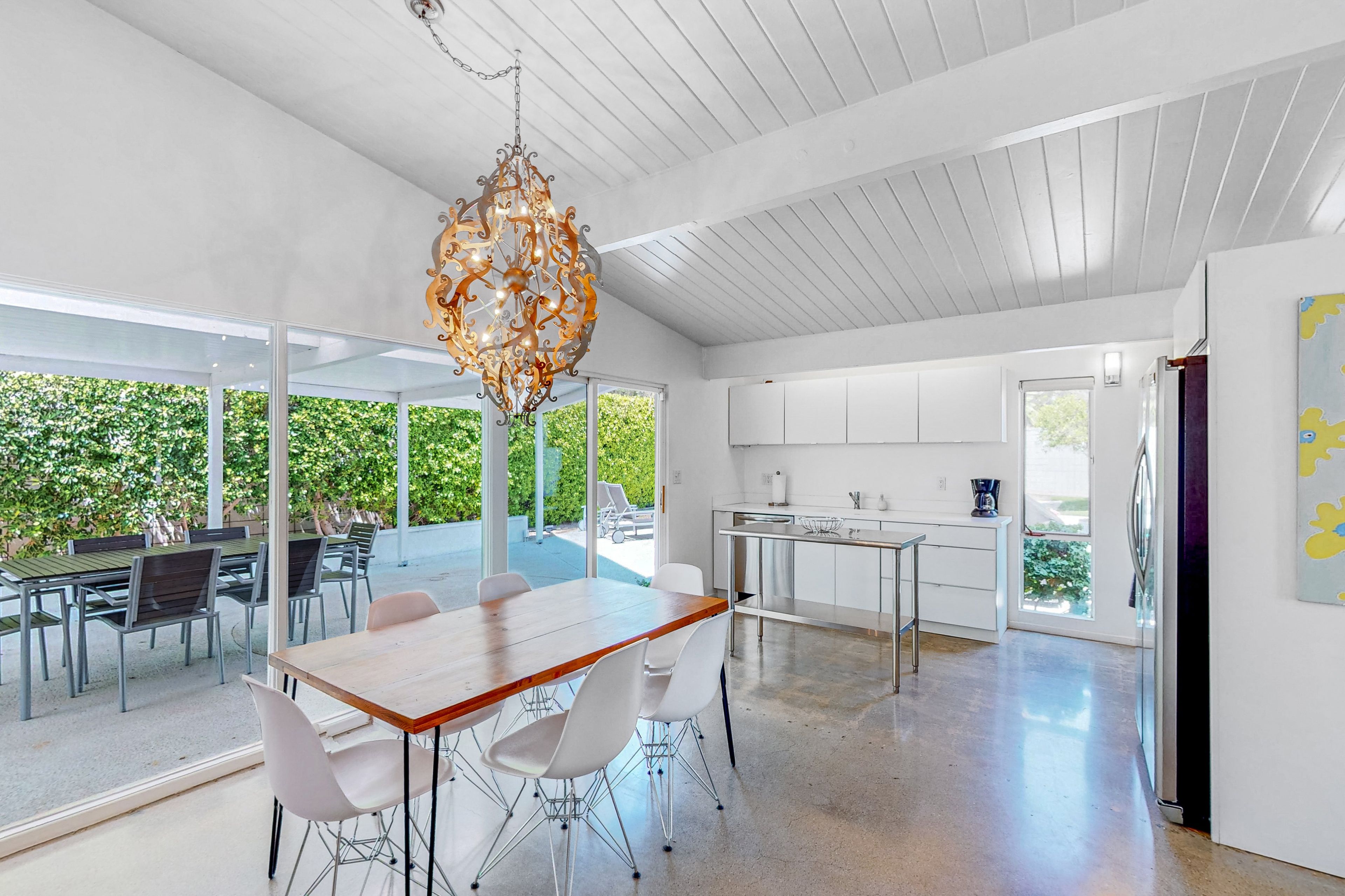 A modern kitchen with white cabinets and a stainless steel countertop.