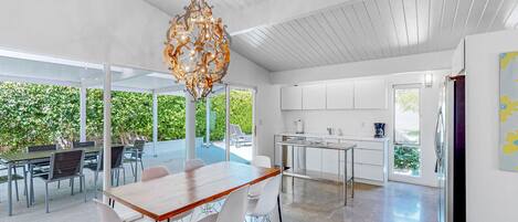 A modern kitchen with white cabinets and a stainless steel countertop.
