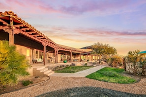 A traditional-style building with a covered patio area, outdoor seating, and a well-maintained garden. - Tucson ranch home with private pool, hot tub, gourmet kitchen, & patio (Marana)