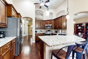 Fridge, microwave, oven, stovetop - Dog-friendly house with firepit, game room, water view, fireplace-30 day stays (Litchfield Park)