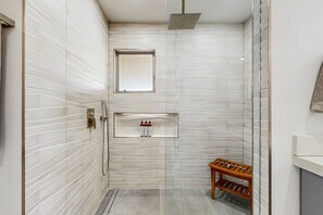 A modern bathroom with a shower, a window, and a shelf with toiletries. - Relax, dine, and explore with ease soak up the sunshine. Home is Dog Friendly. (Palm Springs)