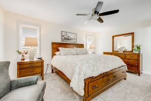 A bedroom with a wooden bed, a nightstand, a dresser, a chair, a ceiling fan, and a window with blinds. - Ground-Floor Home w/Valley Views, Central A/C, Fast WiFi, & Private Washer/Dryer (Sun City)