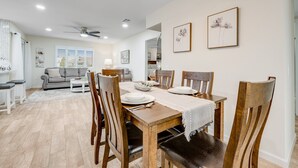 A dining area with a wooden table, chairs, and a ceiling fan. - Ground-Floor Home w/Valley Views, Central A/C, Fast WiFi, & Private Washer/Dryer (Sun City)