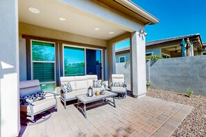 An outdoor patio with a sofa, chairs, and a table. - Beautiful desert home near trailheads with yard, grill, and mtn views - dogs ok (Phoenix)