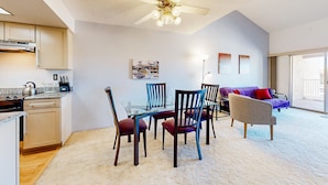 A modern kitchen with a dining area, a ceiling fan, and a large window. - Gorgeous condo with hot tub, pool, tennis court, & grilling area - lake access (Phoenix)