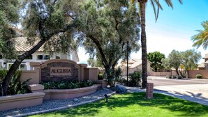 A residential area with a sign reading "AUGUSTA" and a well-maintained lawn. - Delightful golf escape with pool, lawn games, pool table, fast WiFi & central AC (Phoenix)