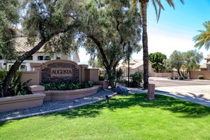 A residential area with a sign reading "AUGUSTA" and a well-maintained lawn. - Delightful golf escape with pool, lawn games, pool table, fast WiFi & central AC (Phoenix)