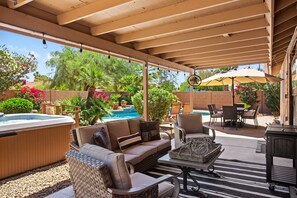 An outdoor patio area with a hot tub, wicker furniture, and a barbecue grill. - Contemporary home with a private pool, hot tub & fast WiFi (Scottsdale)